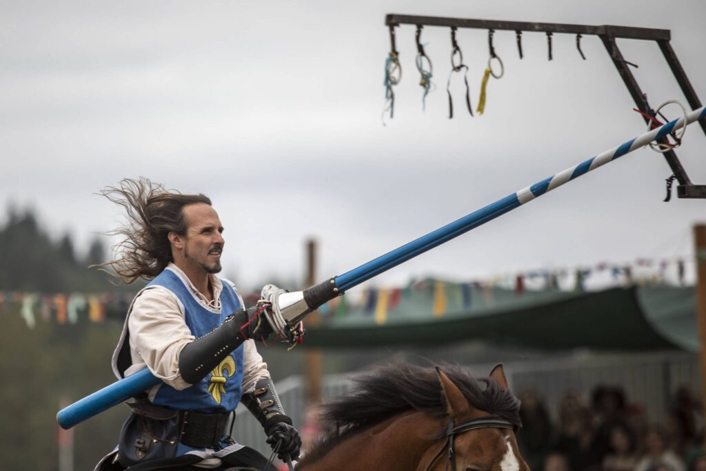 A performer captures a ring during the joust at the Washington Midsummer Renaissance Faire near Monroe. (Annie Barker / The Herald)
