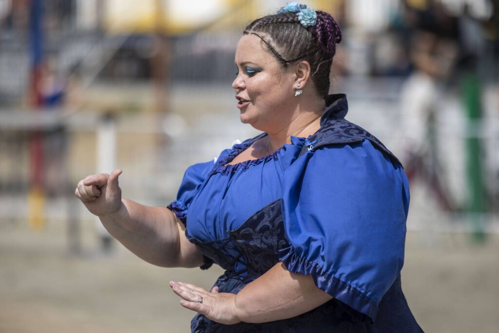 An American Sign Language interpreter translates a falcon show at the Washington Midsummer Renaissance Faire near Monroe on Sunday. (Annie Barker / The Herald)
