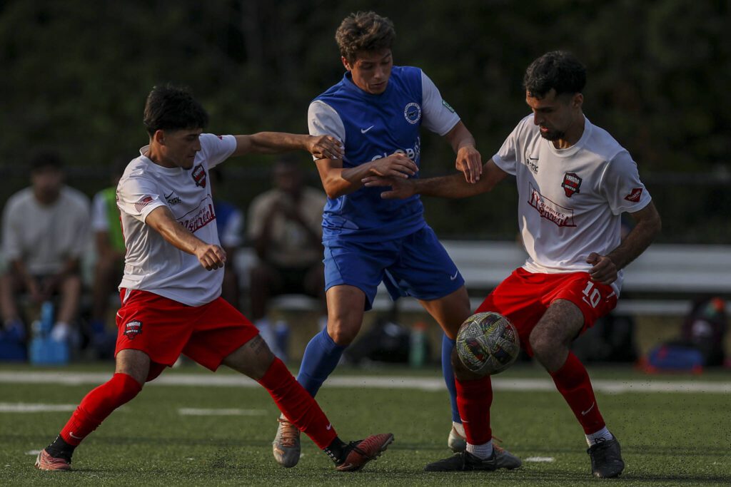 Everett’s Adan Fernandez (13) fights for the ball during the EPLWA championships between semi-pro men’s soccer team Everett Jets FC and Yakima United at Archbishop Murphy High School in Everett, Washington on Saturday, July 27, 2024. Yakima won, 6-1. (Annie Barker / The Herald)
