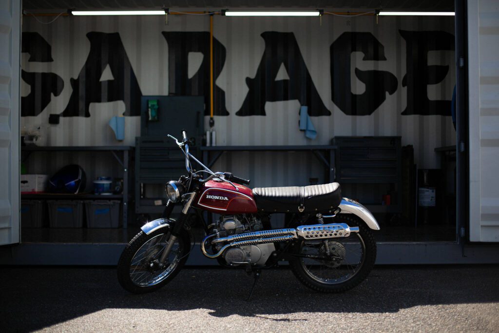 One of the project bikes from Delta Garage’s first year, a Honda CL175, is parked out front of the Delta Garage workspace on July 5 in Everett.
