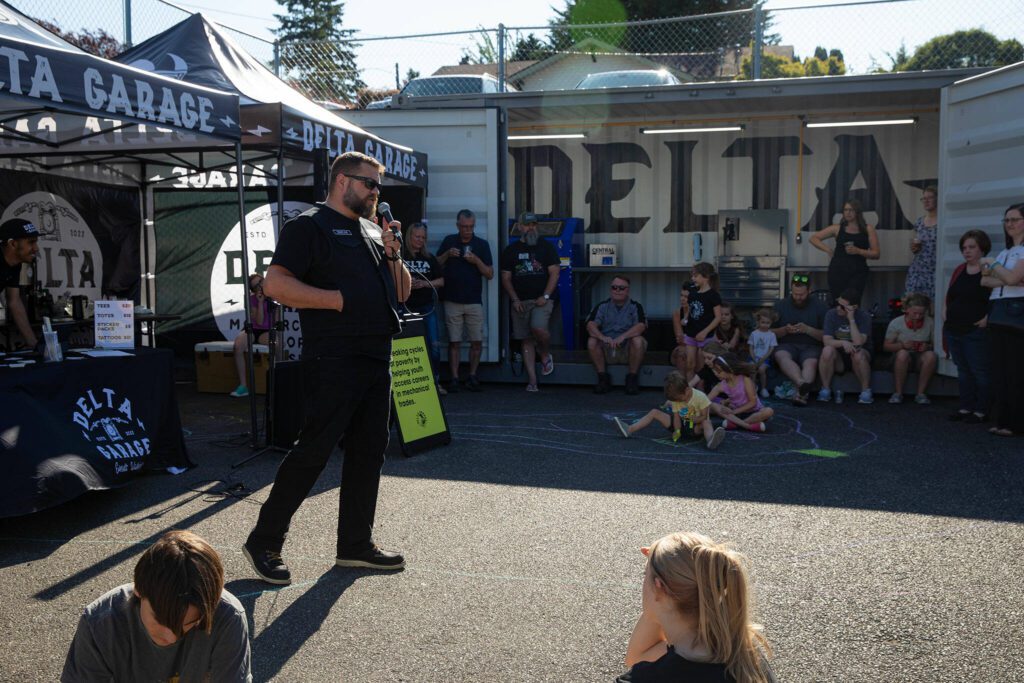 Delta Garage co-founder and chaplain Luke Emerson speaks about the program during an Engage Everett event at Delta Garage on July 10 in Everett. (Ryan Berry / The Herald)
