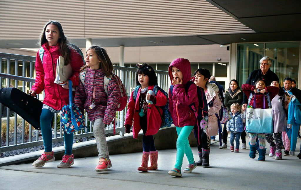 Students arriving for the first day at the new Madrona K-8 school in Edmonds follow teachers to their new classrooms in 2019. (Dan Bates / The Herald)
