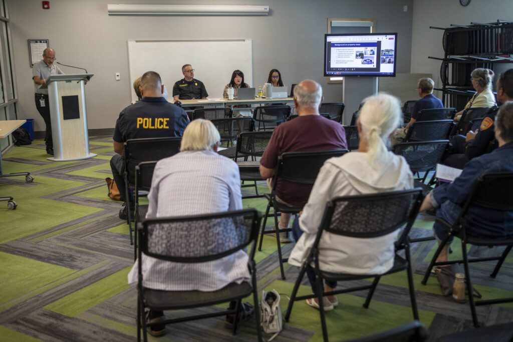 Attendees listen during a public information session hosted by the city of Everett to learn about the city’s property tax levy on the ballot in August at the Everett Public Library Evergreen Branch in Everett, Washington on Saturday, July 27, 2024. (Annie Barker / The Herald)
