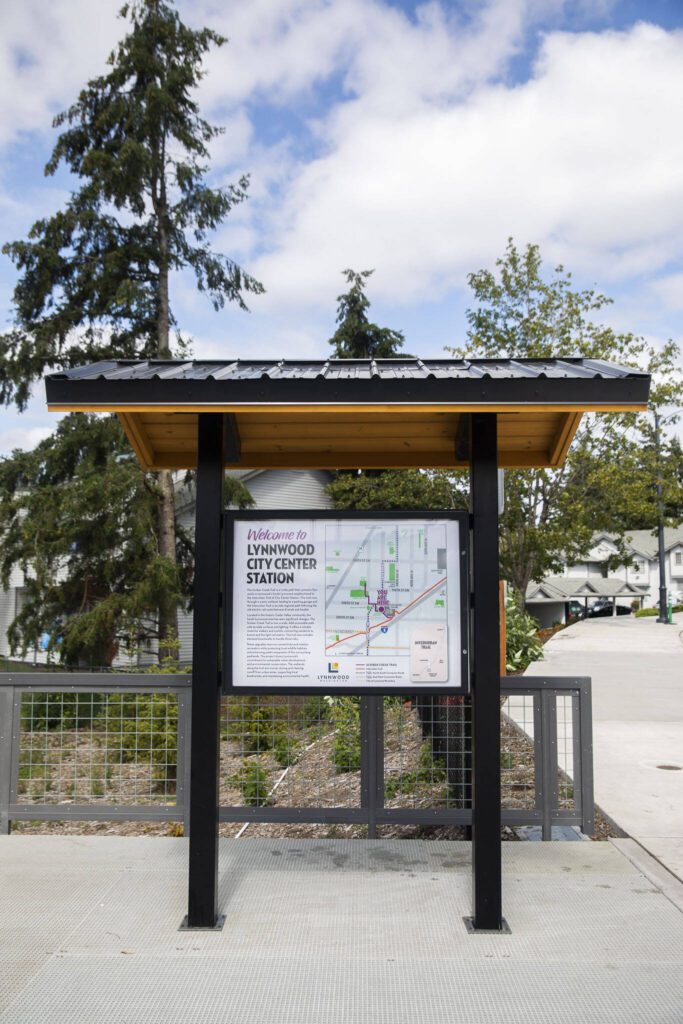 A Lynnwood City Center sign along Scriber Creek Trail on Aug. 12 in Lynnwood. (Olivia Vanni / The Herald)
