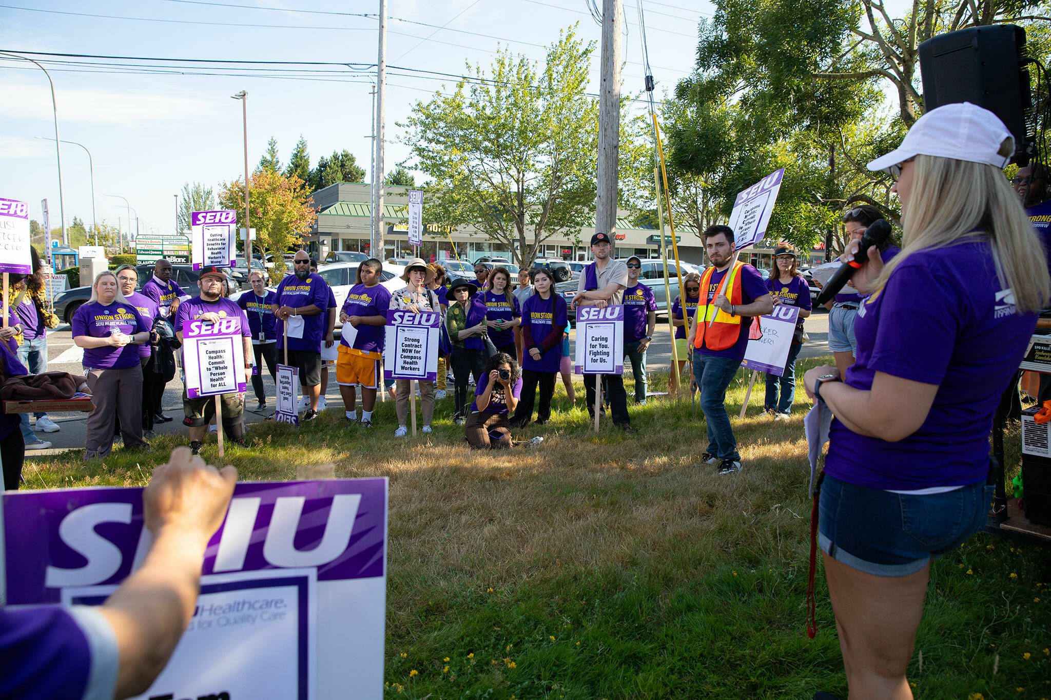 Unionized Compass Health workers from SEIU Healthcare 1199NW gather for a rally and listen to bargaining member Amanda Steffen after picketing in front of the Compass Evaluation and Treatment building on Thursday, Aug. 1, 2024, in Mukilteo, Washington.