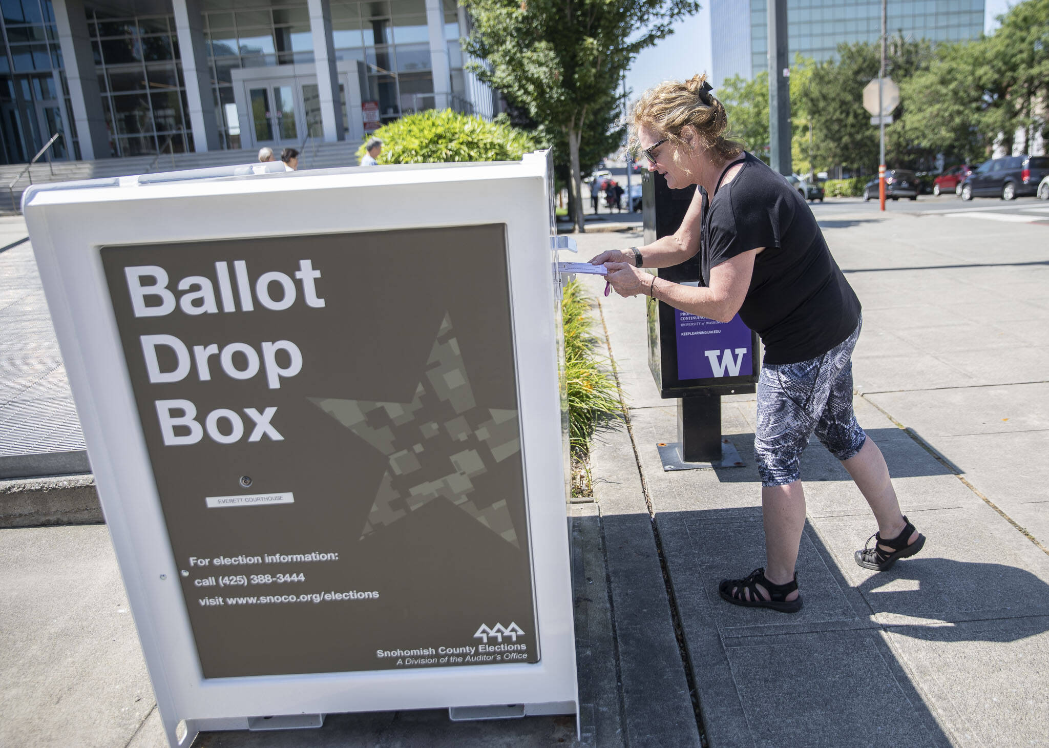 Denise O. turns in ballots at the Snohomish County Campus drop box on Monday, Aug. 5, 2024 in Everett, Washington. (Olivia Vanni / The Herald)