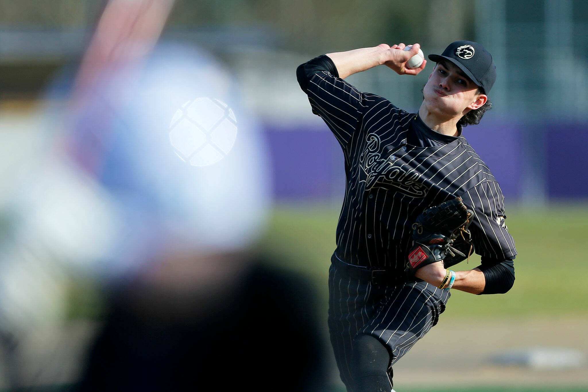 Lynnwood’s starting pitcher Jace Hampson delivers a pitch during a game against Lake Stevens on Friday, March 17, 2023, at Lake Stevens High School in Lake Stevens, Washington. (Ryan Berry / The Herald)
