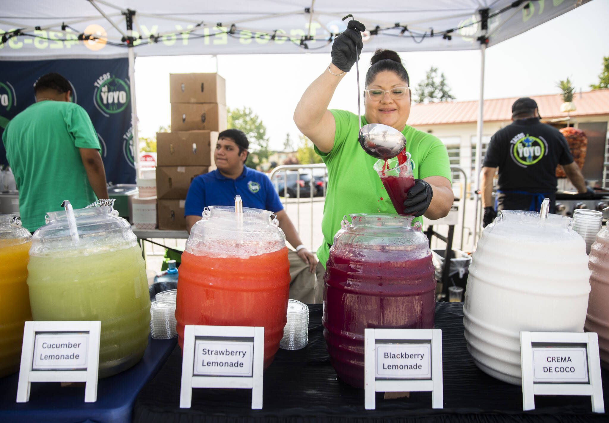 Fabiola Vazquez-Mora, of Tacos el Yoyo, pours a blackberry lemonade at Taste Edmonds on Friday in Edmonds. (Olivia Vanni / The Herald)