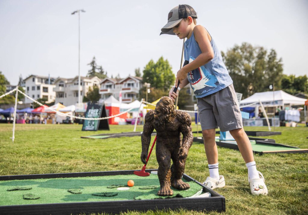 Seamus Mazerolle, 7, plays putt putt at Taste Edmonds on Friday in Edmonds. (Olivia Vanni / The Herald)
