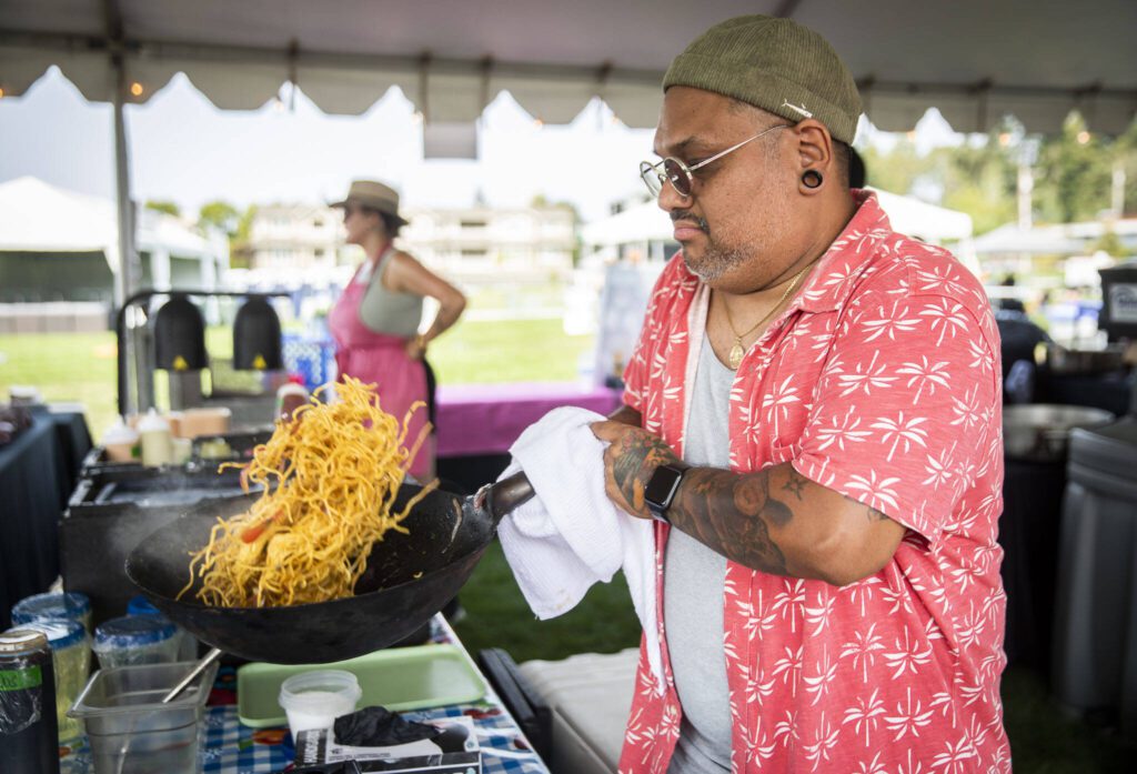 Jose Garzon cooks up vegetable soba saltado at Taste Edmonds on Friday in Edmonds. (Olivia Vanni / The Herald)
