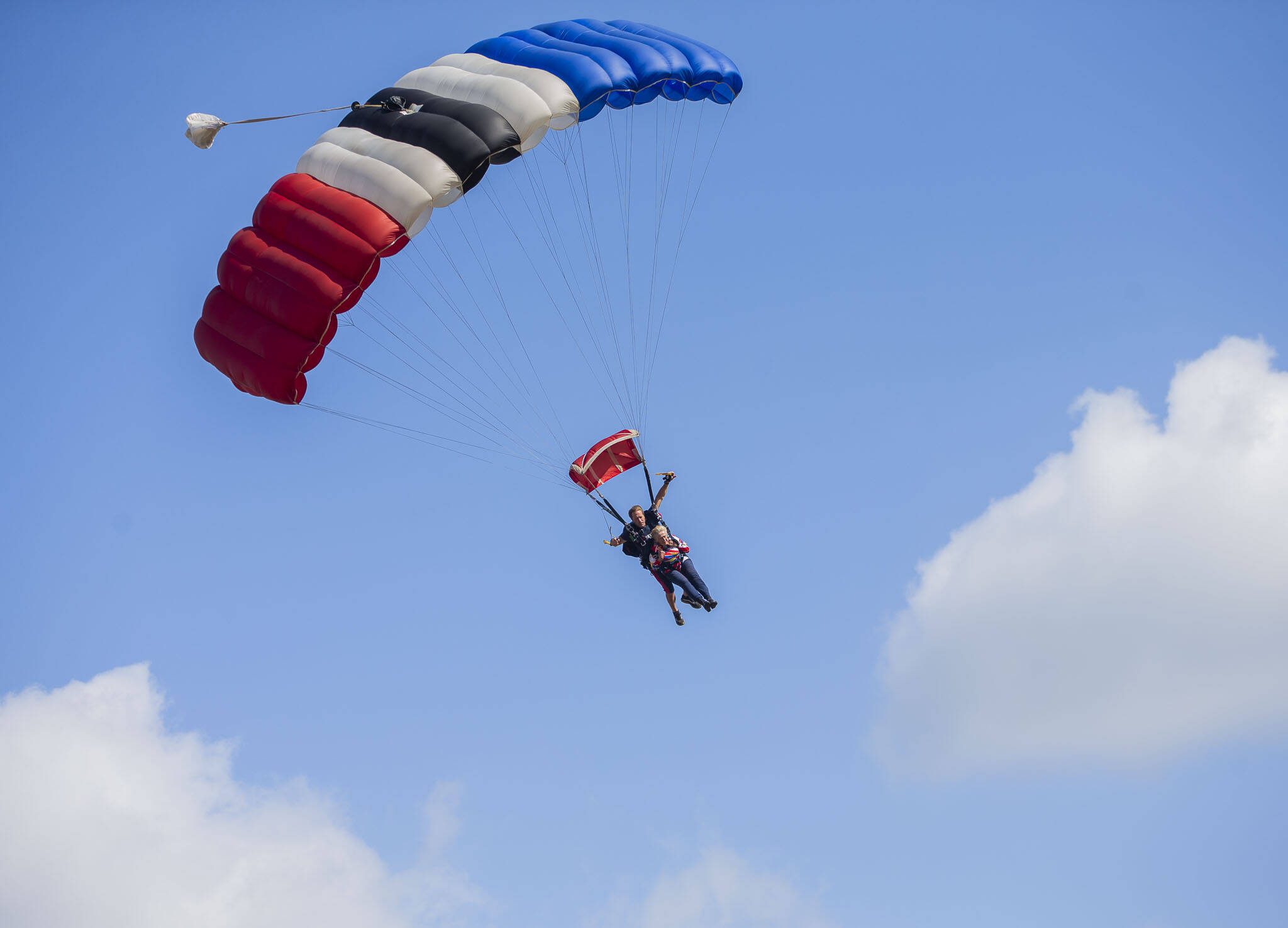 Kim Knor, 85, in tandem with Skydive Snohomish’s Kelly Craig, descends after her 730th skydive on her journey to 1,000 skydives on Wednesday, Aug. 14, 2024 in Snohomish, Washington. (Olivia Vanni / The Herald)