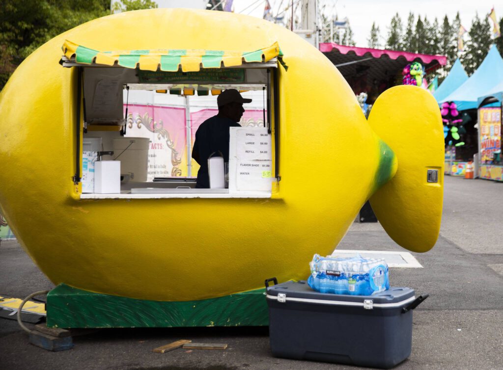 Workers set up vendor booths before the start of the Evergreen State Fair on Wednesday, Aug. 21, 2024, in Monroe, Washington. (Olivia Vanni / The Herald)
