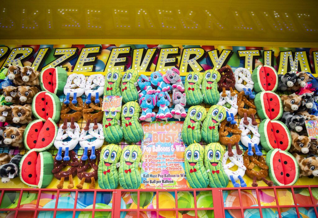 Different stuffed prizes cover carnival booths at the Evergreen State Fair on Wednesday, Aug. 21, 2024 in Monroe, Washington. (Olivia Vanni / The Herald)
