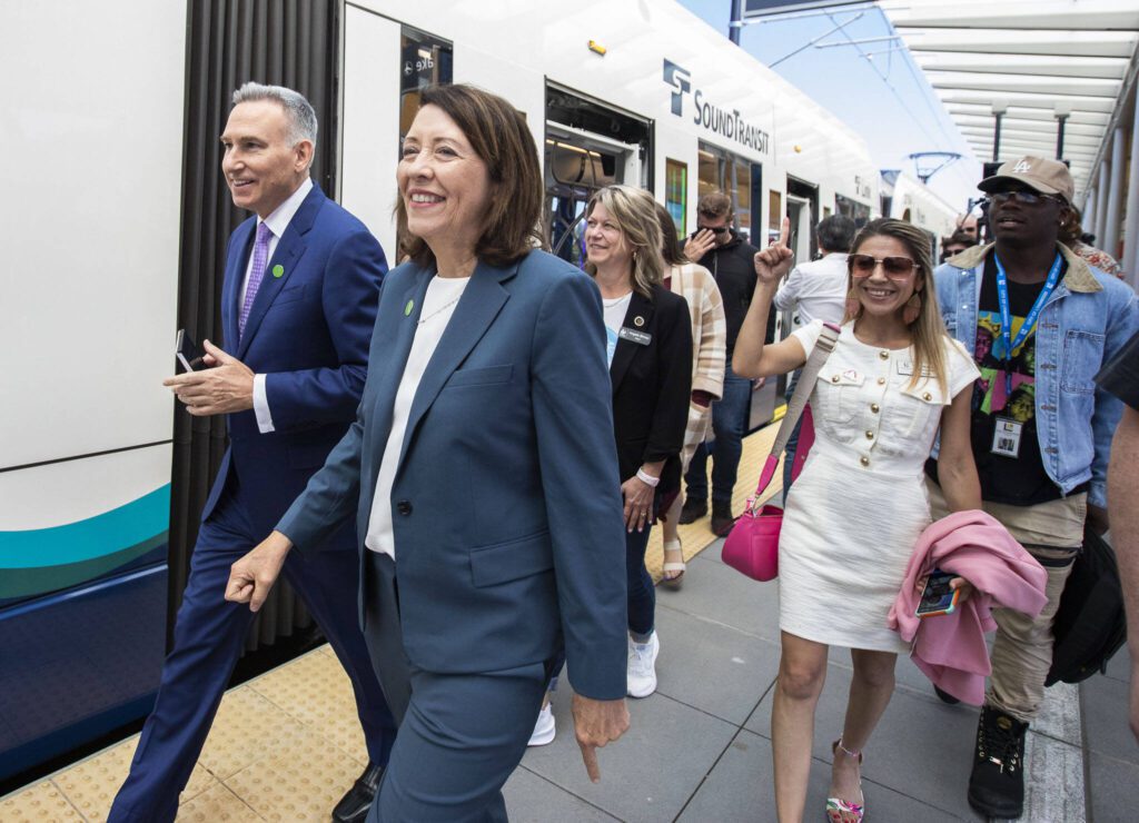 King County Executive Dow Constantine and Senator Maria Cantwell walk through the Lynnwood Center Station to board the 12:30 pm train during the Lynnwood 1 Line extension opening celebrations on Friday, Aug. 30, 2024 in Lynnwood, Washington. (Olivia Vanni / The Herald)

