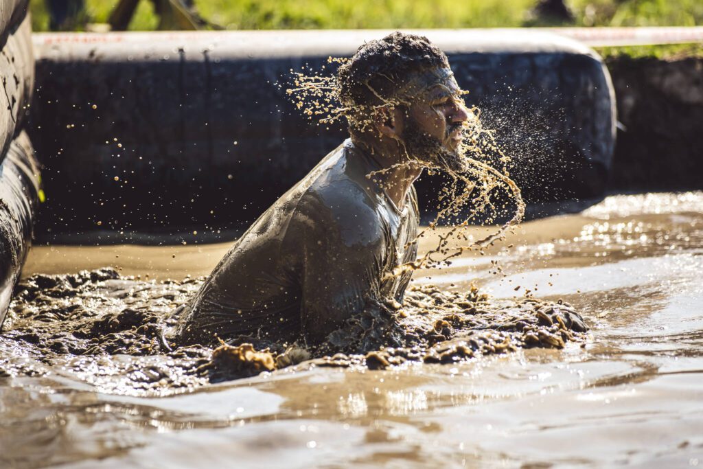 A man takes a dip in the mud during a challenge at the 2023 Seattle Spartan Trifecta Weekend in Snohomish, Washington. (Photo courtesy of Spartan Race Staff)
