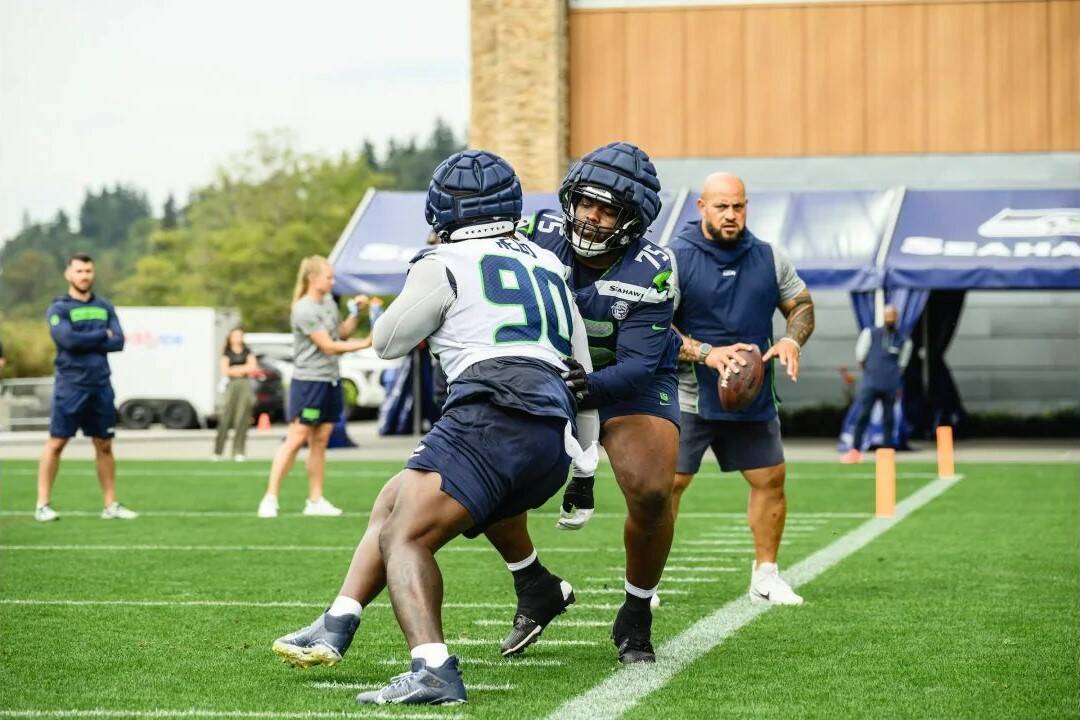 Seahawks guard Anthony Bradford (75) and nose tackle Jarran Reed (90) practice at the Virginia Mason Athletic Center in Renton on August 19, 2024. (Photo courtesy of Edwin Hooper / Seattle Seahawks)