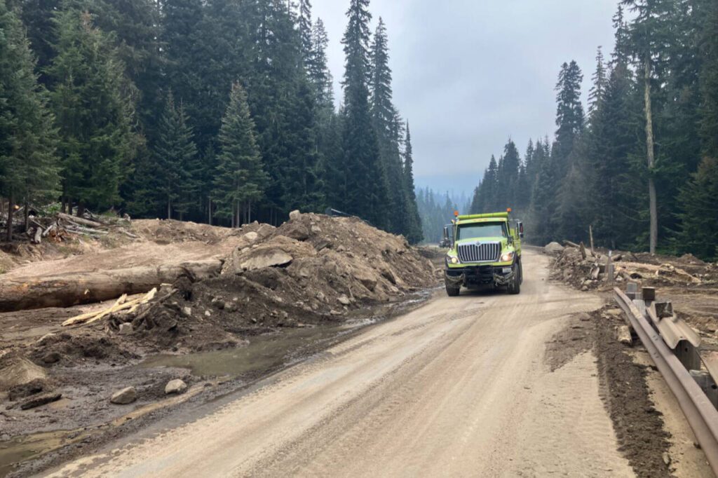 A dump truck passes through the mudslide cleanup area on Highway 20 in the North Cascades. The slide happened Aug. 11 after heavy rain. (Photo provided by WSDOT)
