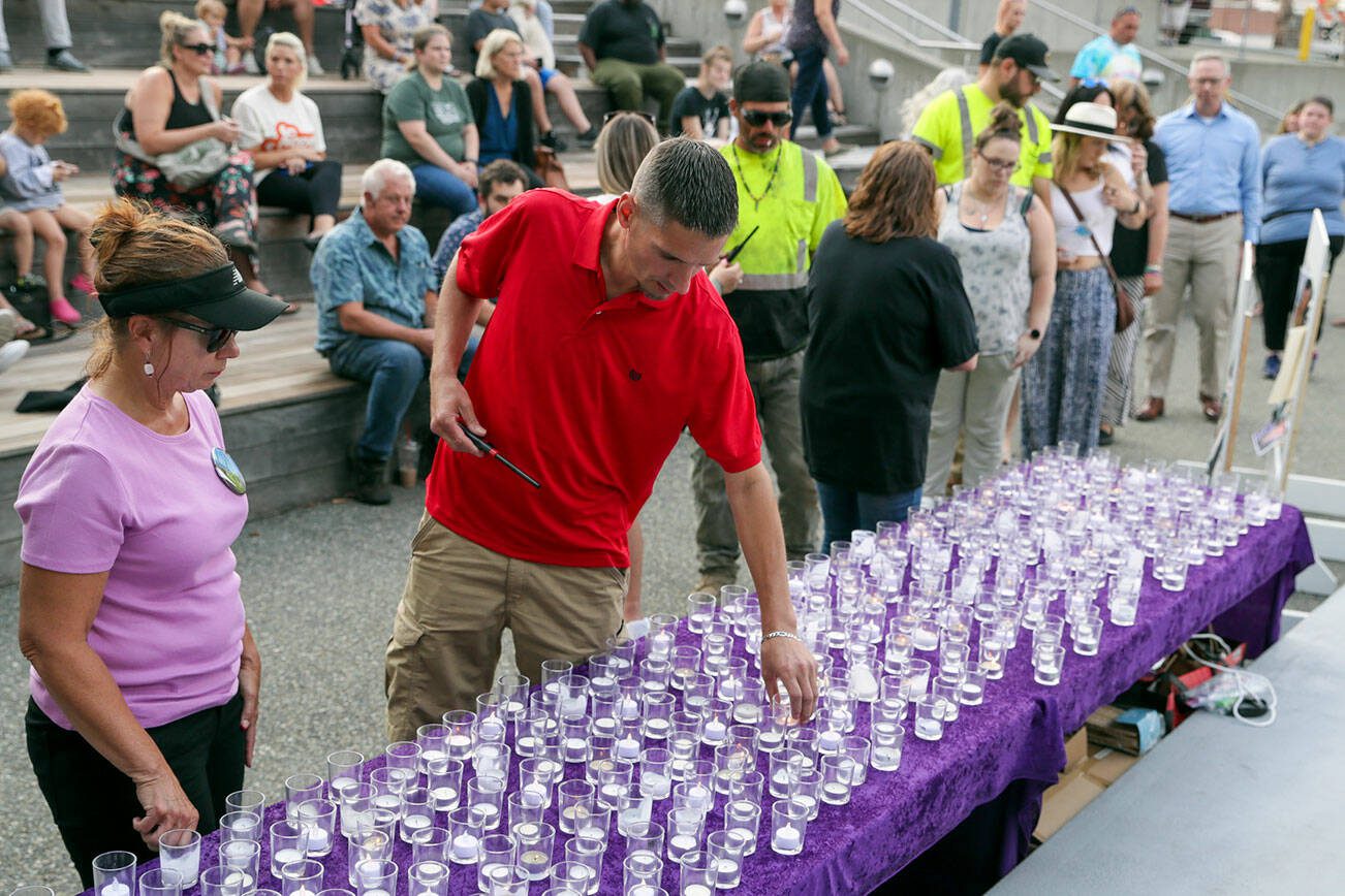 Kevin Clark / The Herald 
Friends and family line up to light a candle for those lost to an overdose during the 6th annual “A Night To Remember, A Time To Act” in Everett in 2022.