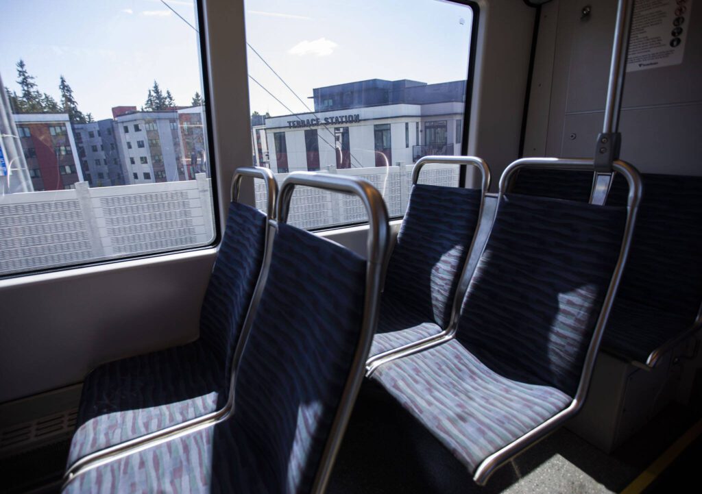 Terrace Station apartments are visible outside of the Link light rail as it moves southbound on Wednesday, Aug. 28, 2024 in Mountlake Terrace, Washington. (Olivia Vanni / The Herald)
