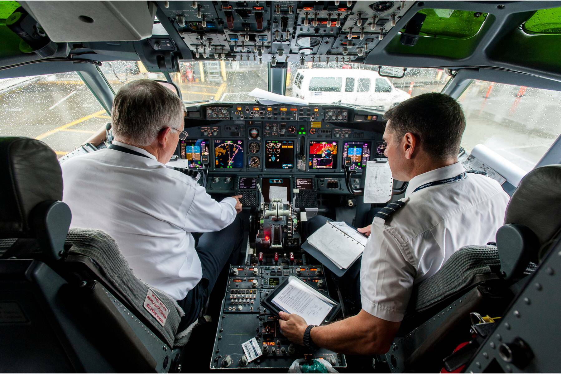 Alaska Airlines Captain Ted Leenerts, left, and First Officer Andrew Blank start pre-flight checks in a Boeing 737 at Seattle-Tacoma International Airport in 2012. (Stuart Isett/The New York Times)