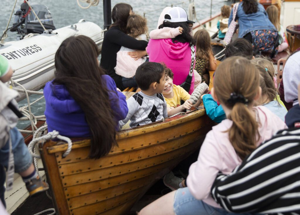 Kids sit in a lifeboat and listen to stories during the Everett Public Library’s Day Aboard the Adventuress on Tuesday, Aug. 27, 2024 in Everett, Washington. (Olivia Vanni / The Herald)
