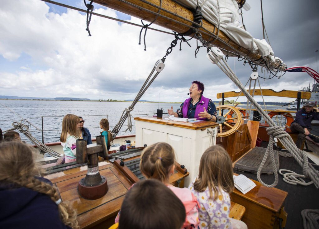 Aarene Storms read stories from the deck of the Adventuress on Tuesday, Aug. 27, 2024 in Everett, Washington. (Olivia Vanni / The Herald)
