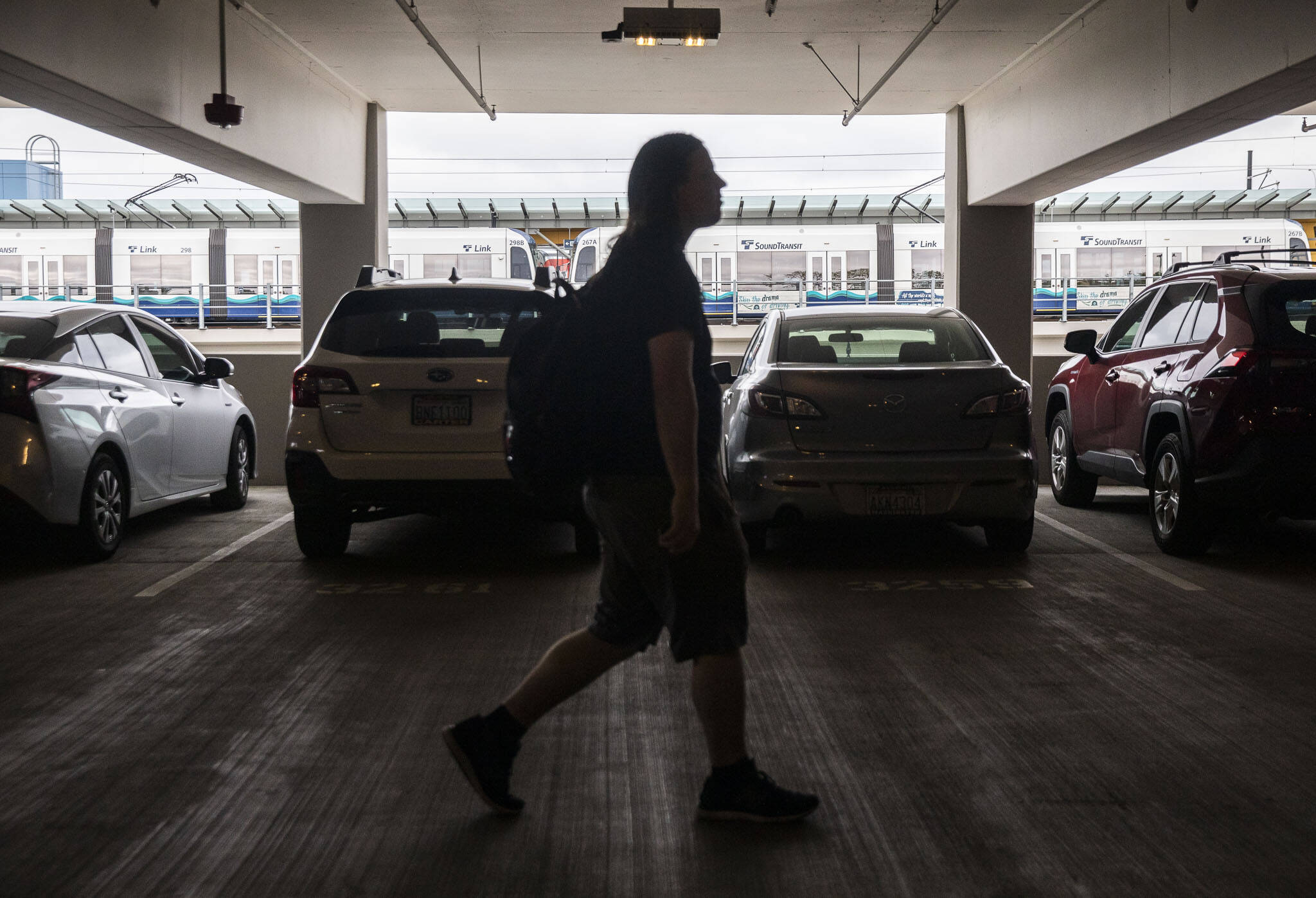 A commuter walks through a packed Lynnwood City Center station parking garage to the Link train on Tuesday, Sept. 3, 2024 in Lynnwood, Washington. (Olivia Vanni / The Herald)