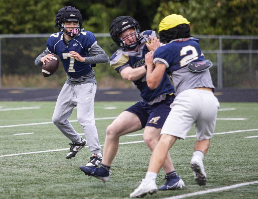 Arlington’s Leyton Martin scrambles as he looks for an open teammate to pass to during practice on Monday, Sept. 2, 2024 in Arlington, Washington. (Olivia Vanni / The Herald)
