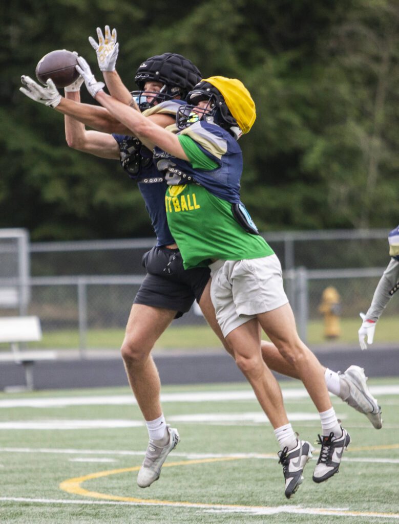 Arlington’s Kade Hunter leaps in the air and blocks a pass during practice on Monday, Sept. 2, 2024 in Arlington, Washington. (Olivia Vanni / The Herald)
