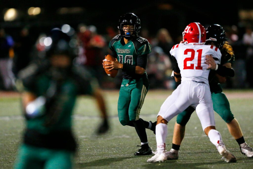 Marysville Getchell junior quarterback Arion Palacol rolls out of the pocket while looking to pass against Marysville Pilchuck during the Berry Bowl on Friday, Sept. 15, 2023, at Quil Ceda Stadium in Marysville, Washington. (Ryan Berry / The Herald)
