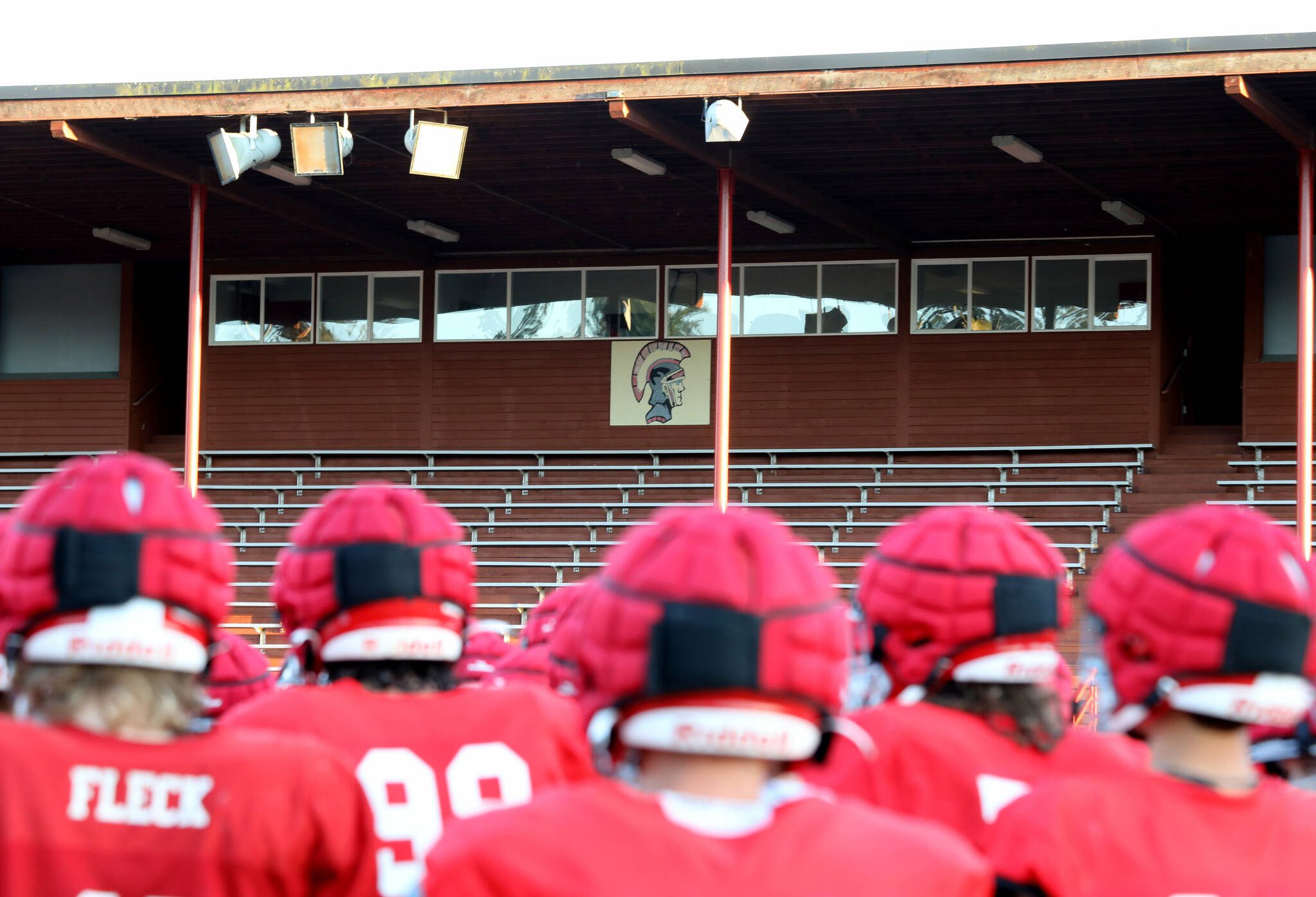 A team photo with the Stanwood High School Spartans logo in the background at Bob Larson Stadium in Stanwood, Washington on Aug. 30, 2024. (Taras McCurdie / The Herald)