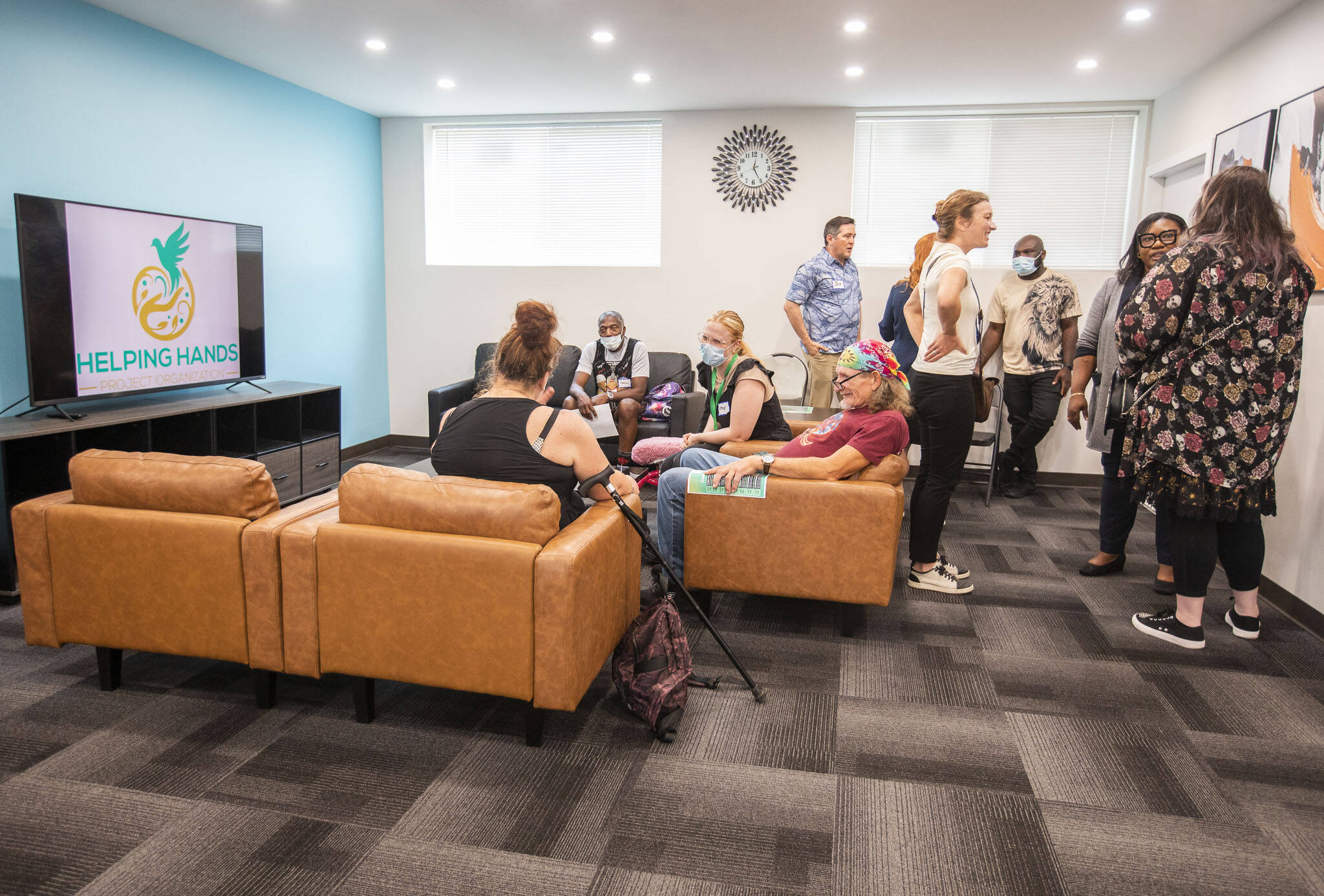People chat at a gathering for Helping Hands newly expanded outpatient behavioral health facility on Friday, Sept. 6, 2024 in Everett, Washington. (Olivia Vanni / The Herald)