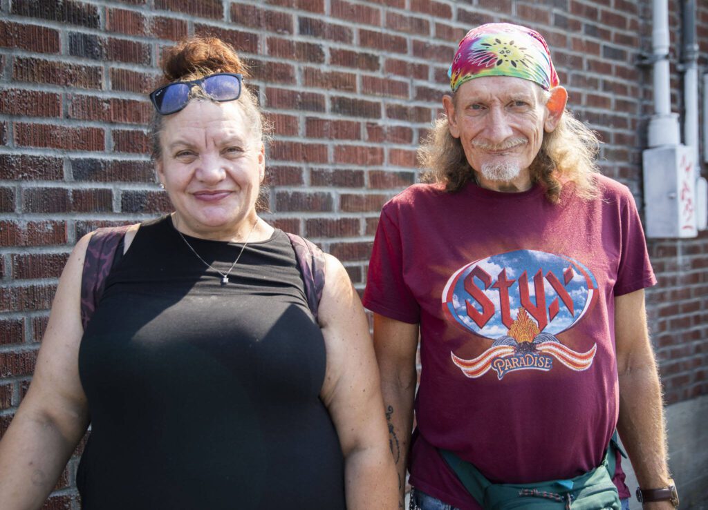 Helping Hands clients Dawn Eastman, left, and Fred Prain, right, outside of the newly expanded facility on Friday, Sept. 6, 2024 in Everett, Washington. (Olivia Vanni / The Herald)
