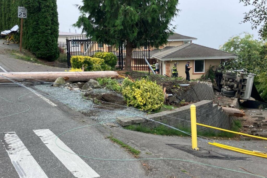 A dump truck crashed into an Edmonds home and knocked out power lines Wednesday morning. (Courtesy of Edmonds Police Department)
