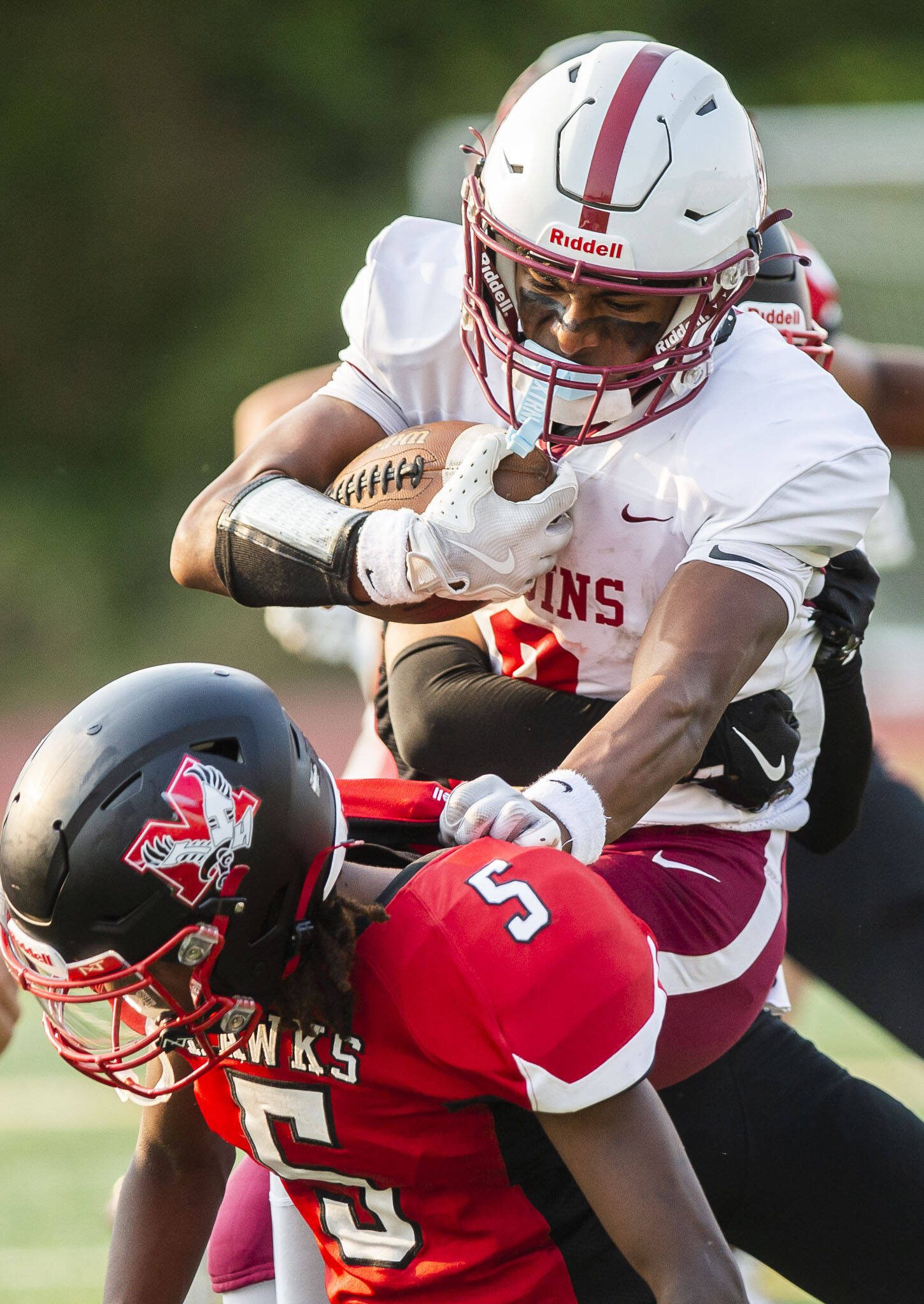 Cascade’s Andi Cosme sticks his arm out to leap over Mountlake Terrace’s Aaron Hatfield while being tackled during the game on Friday, Sept. 6, 2024 in Edmonds, Washington. (Olivia Vanni / The Herald)