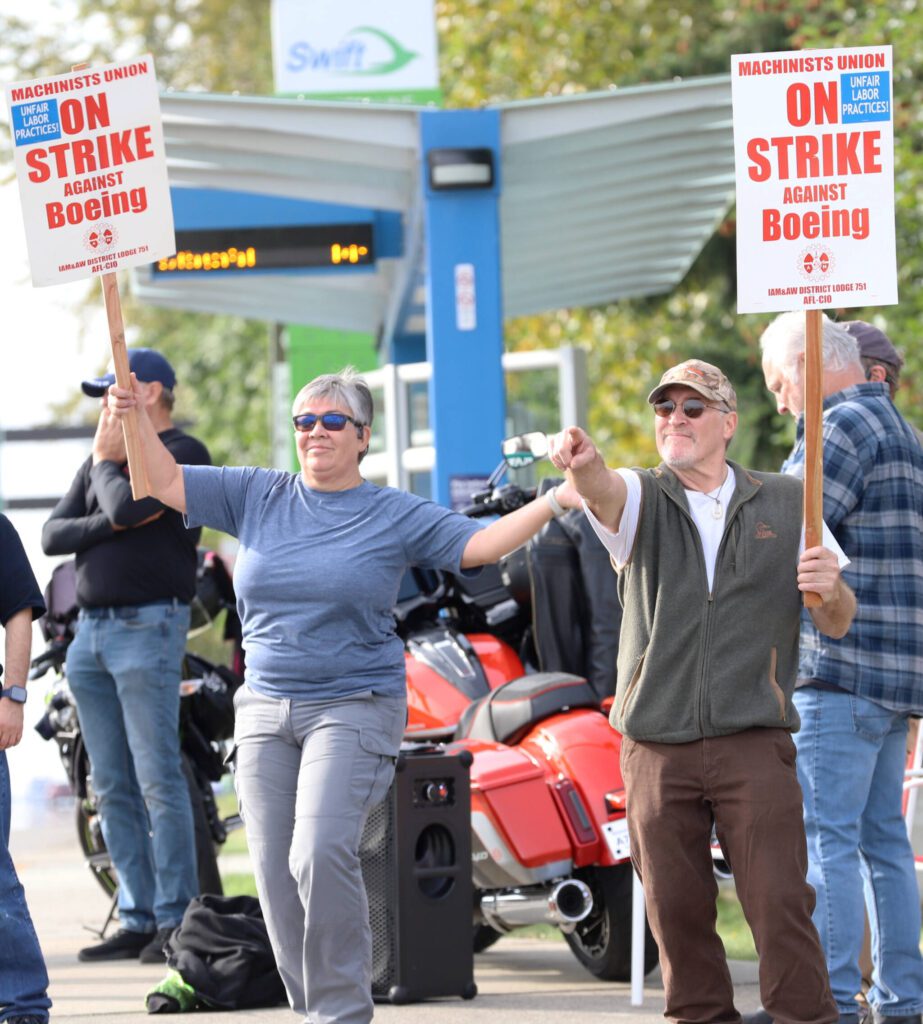 From left, Vivian Gherman and Bartley Stokes Sr. picket next to the Everett Boeing plant on Friday, Sept. 13, 2024, in Everett, Washington. (Michael Henneke / The Herald)
