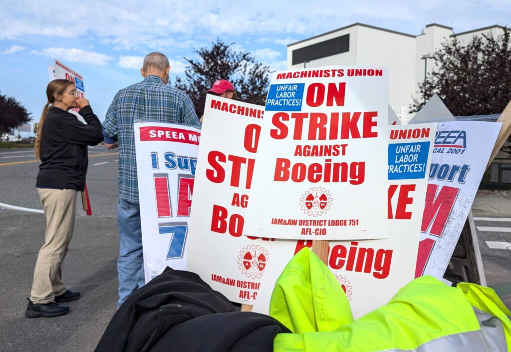 A bin holds a number of strike signs during a picket by the Boeing Machinists union at the Everett Boeing plant on Friday, Sept. 13, 2024, in Everett, Washington. (Michael Henneke / The Herald)

