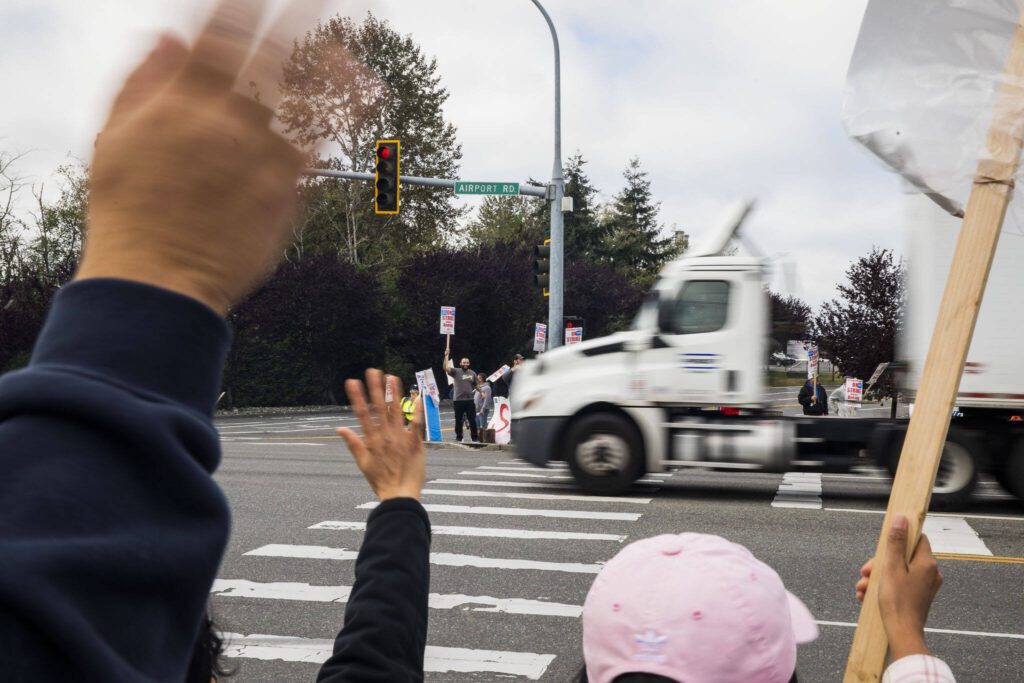 A truck honks in support of picketing Boeing workers along Airport Road on Monday, Sept. 16, 2024, in Everett, Washington. (Olivia Vanni / The Herald)

