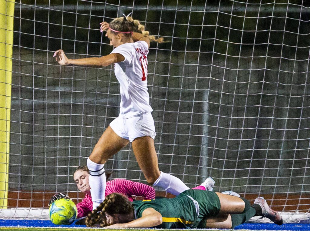 Archbishop Murphy’s Kylie Hendry scrambles for a loose ball in front of the goal while Shorecrest’s Kylee Mitchell reaches out to get a hand on the ball during the game on Tuesday, Sept. 17, 2024 in Shoreline, Washington. (Olivia Vanni / The Herald)
