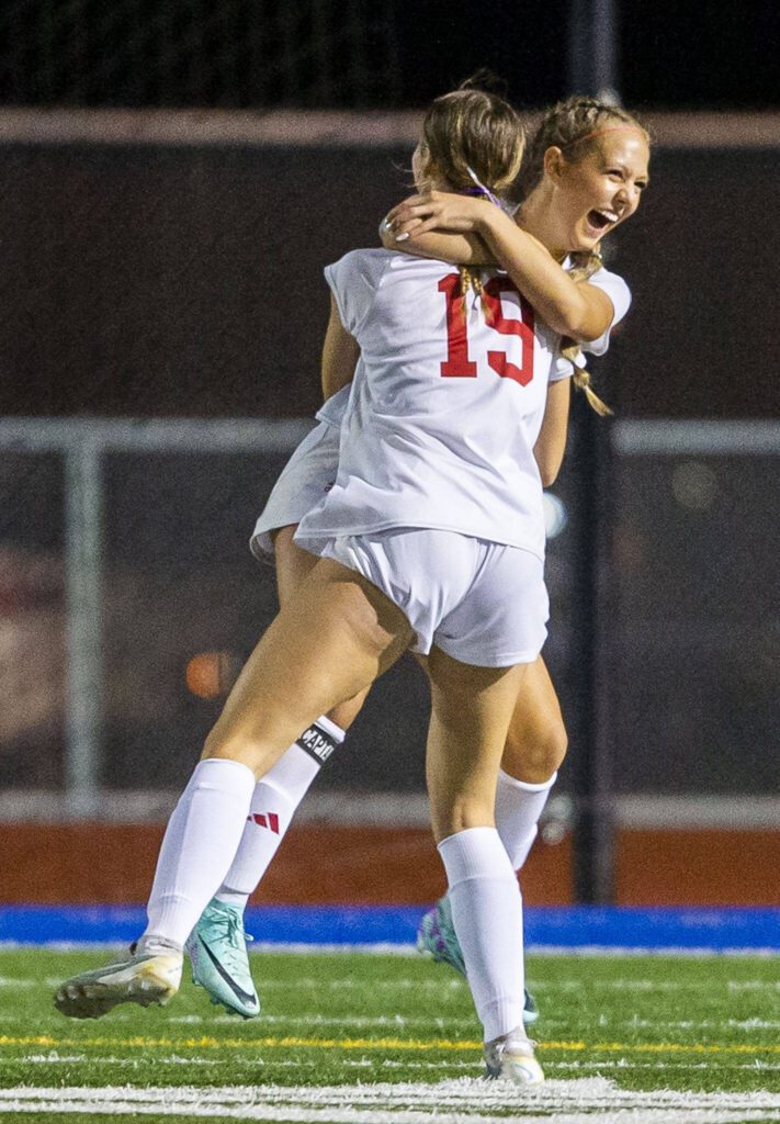 Archbishop Murphy’s Chloe McCoy is hugged by teammate Julianne Buchan after scoring during the game on Tuesday, Sept. 17, 2024 in Shoreline, Washington. (Olivia Vanni / The Herald)
