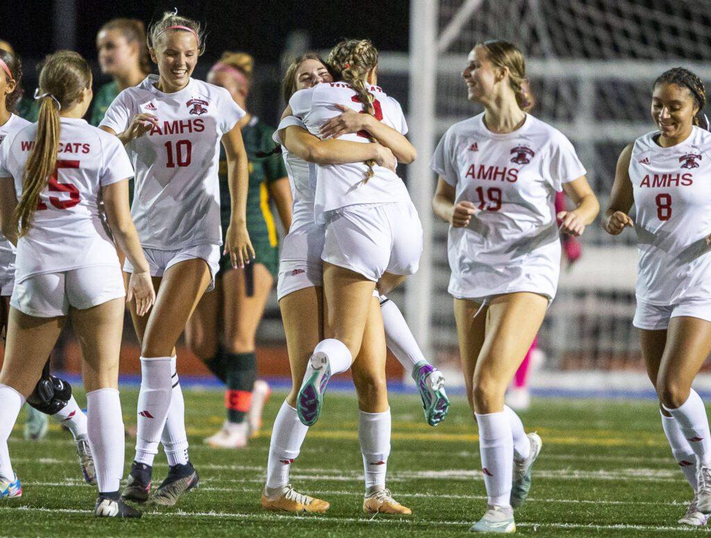 Archbishop Murphy’s Chloe McCoy is hugged by teammates after scoring during the game against Shorecrest on Tuesday, Sept. 17, 2024 in Shoreline, Washington. (Olivia Vanni / The Herald)
