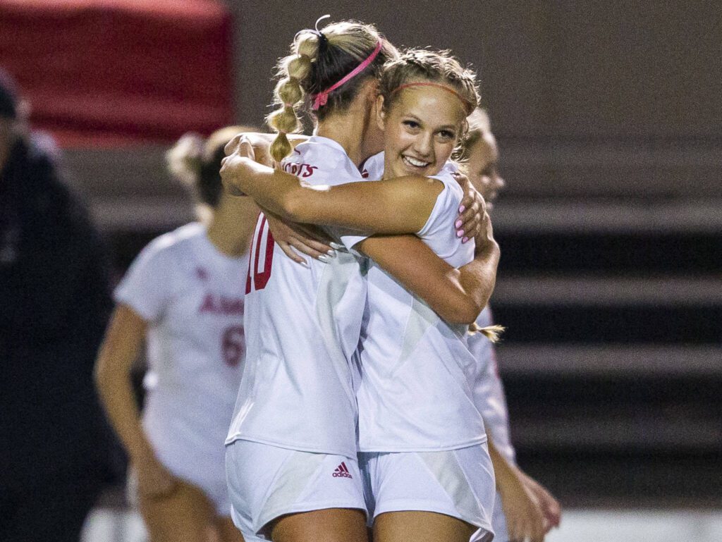 Archbishop Murphy’s Chloe McCoy hugs teammate Kylie Hendry after beating Shorecrest on Tuesday, Sept. 17, 2024 in Shoreline, Washington. (Olivia Vanni / The Herald)
