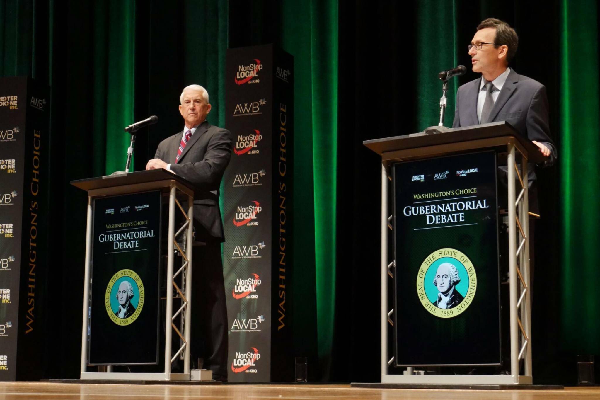Former congressman Dave Reichert, a Republican, left, and state Attorney General Bob Ferguson, a Democrat, right, on stage during the second debate of the governor’s race on Wednesday in Spokane. (Bill Lucia/Washington State Standard)