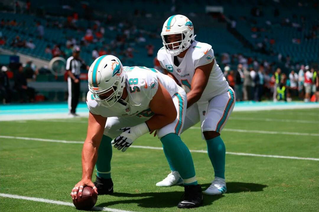 Connor Williams (58), now with the Seattle Seahawks, prepares to snap the ball to Tua Tagovailoa prior to a game against the New England Patriots on Sunday, Sept. 11, 2022 in Miami Gardens, Fla. (Photo courtesy of Perry Knotts / Perry Knots Photography and the Seattle Seahawks)