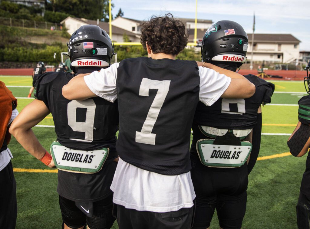 Will Turpin hangs out with his teammates Jason Pham, left, and Cole Truant, right, as they warm up for their game on Friday, Sept. 20, 2024 in Everett, Washington. (Olivia Vanni / The Herald)
