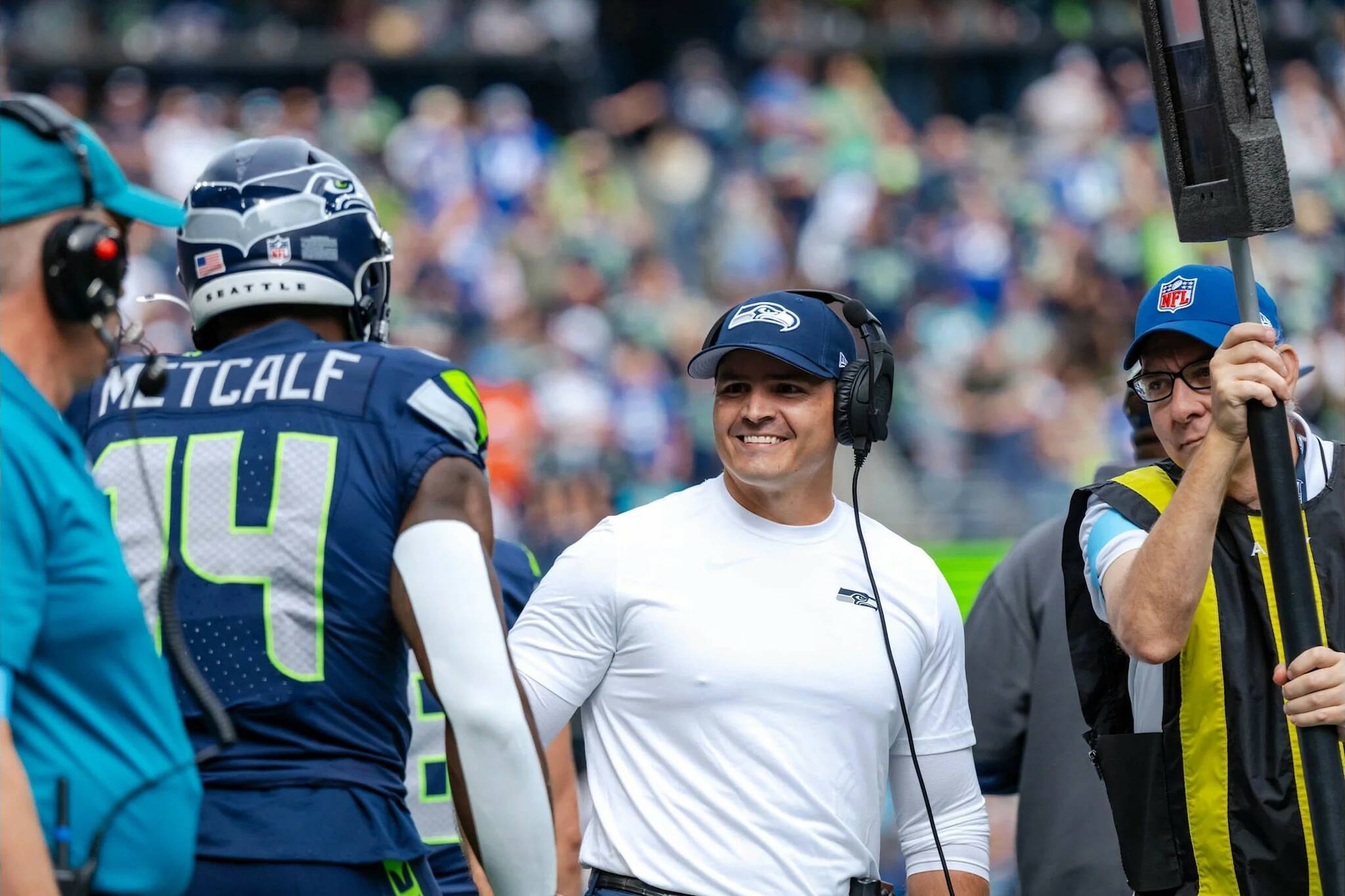 Seahawks head coach Mike Macdonald greets receiver DK Metcalf (14) during a game against the Miami Dolphins at Lumen Field on Sunday, Sept. 22, 2024. (Photo courtesy of Edwin Hooper / Seattle Seahawks)