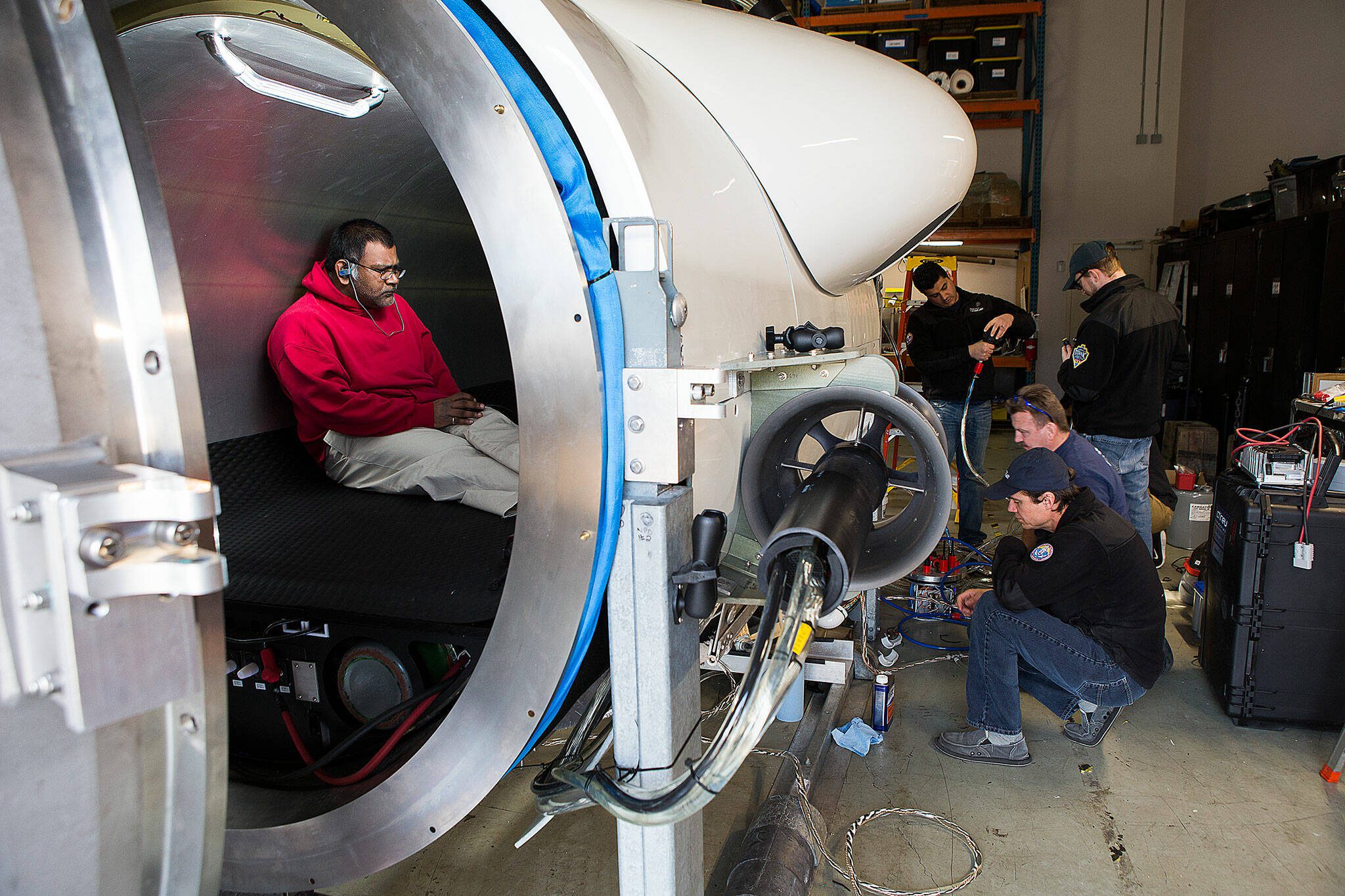 OceanGate engineer Mark Walsh programs control software as engineering technicians get the Titan submersible ready for testing in 2018 in Everett. (Andy Bronson / The Herald)