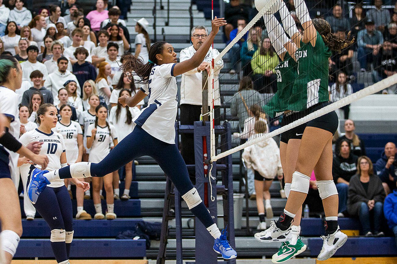 Glacier Peak’s Hanna Ligons tips the ball over the next during the game against Jackson on Wednesday, Sept. 25, 2024 in Snohomish, Washington. (Olivia Vanni / The Herald)