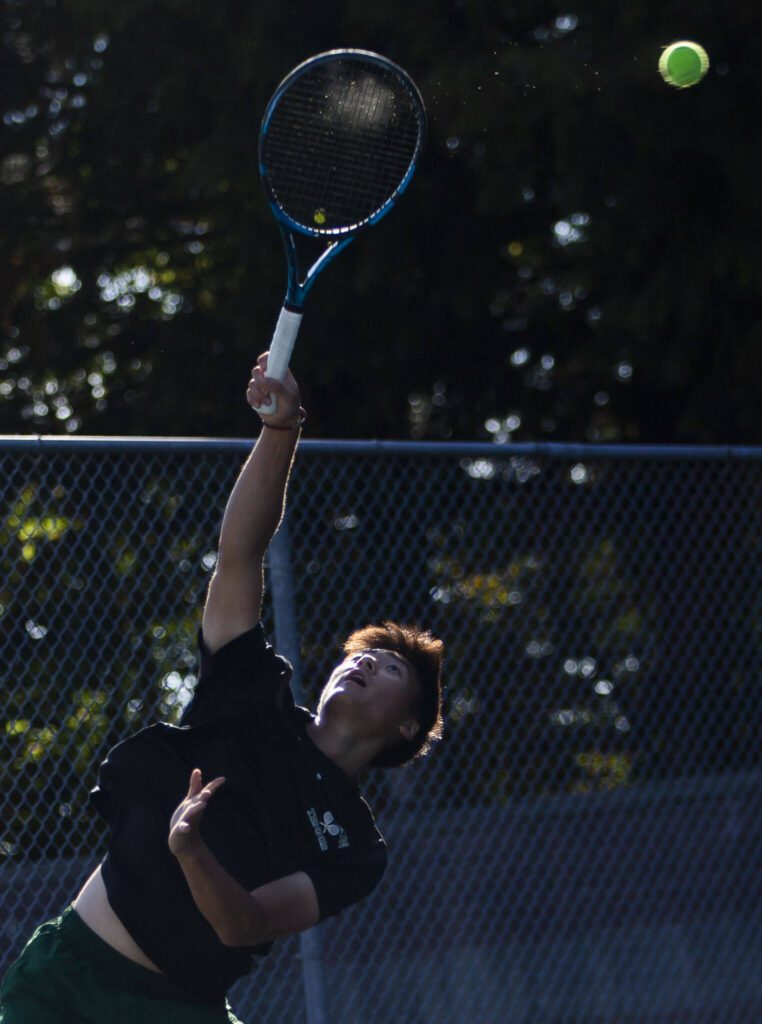 Jackson’s Ben Lee serves during a doubles match again Kamiak on Monday, Sept. 30, 2024 in Mill Creek, Washington. (Olivia Vanni / The Herald)
