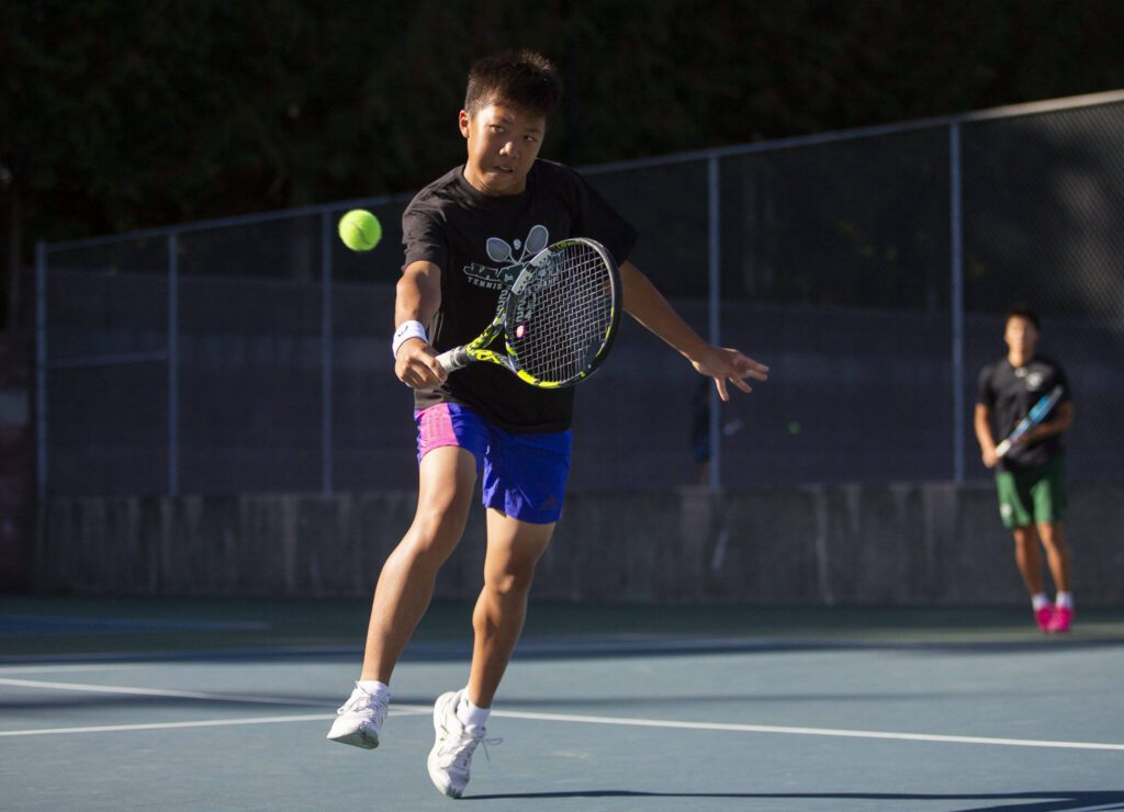 Jackon’s Samuel Song hits the ball during a doubles match against Kamiak on Monday, Sept. 30, 2024 in Mill Creek, Washington. (Olivia Vanni / The Herald)
